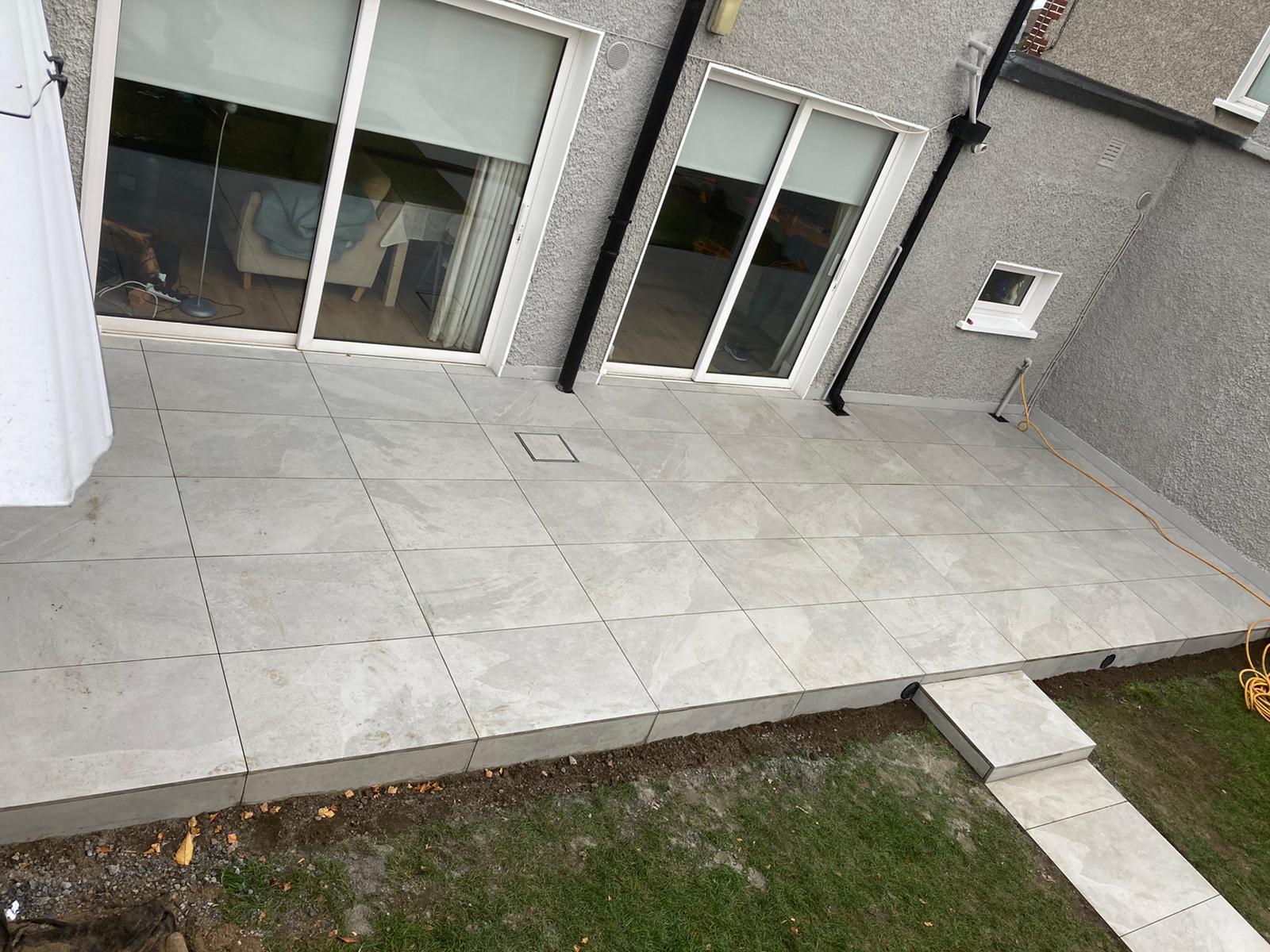 Elevated view of the finished porcelain patio beside sliding doors