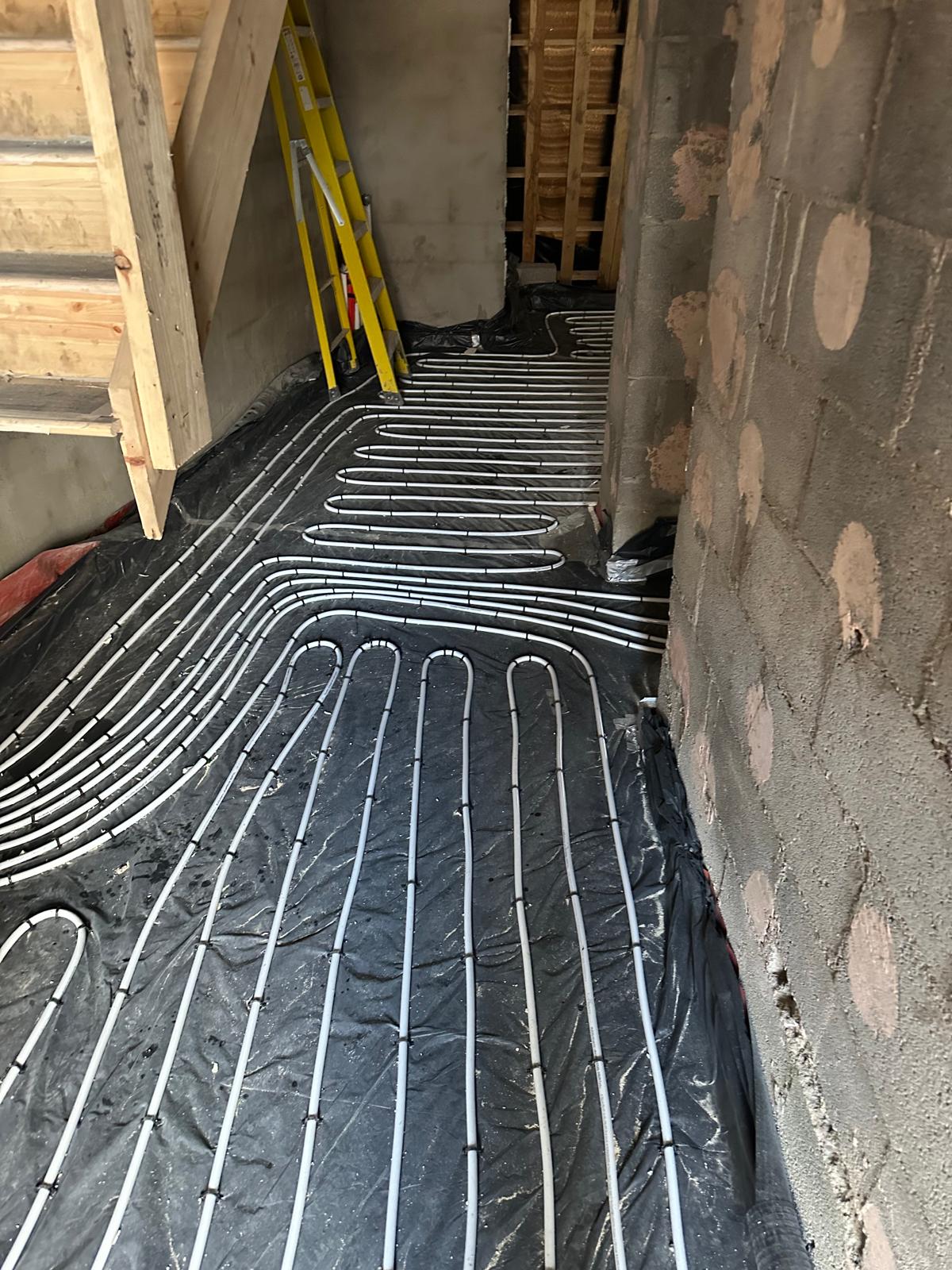 Underfloor heating pipework laid through the hallway before screeding