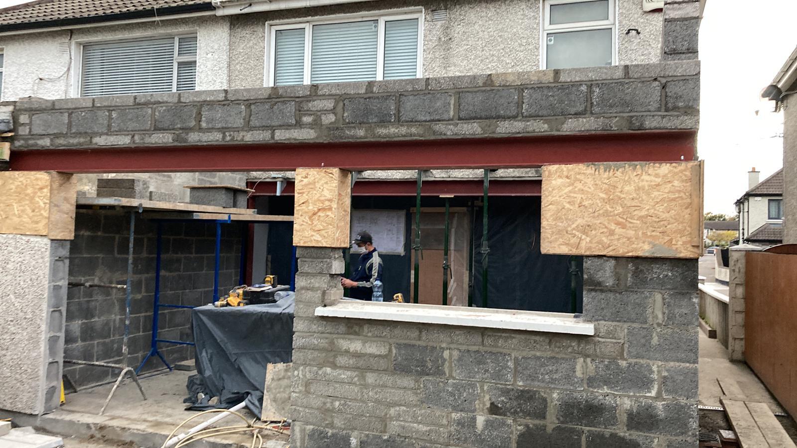 Extension blockwork with structural steel beam during construction